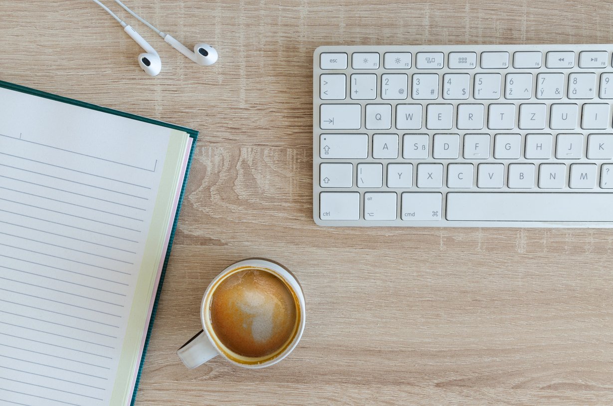 Top View of Keyboard, Notebook and Coffee Cup